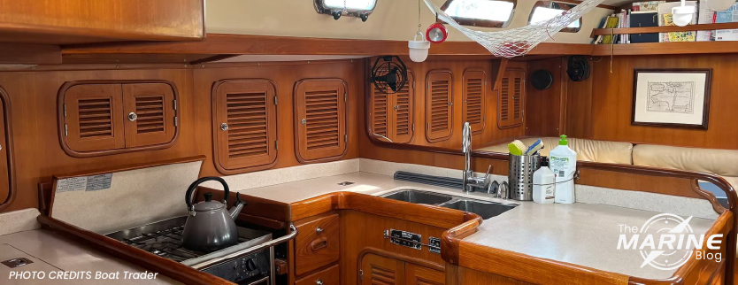 cucina-interna-di-una-barca-con-fornello-lavello-e-arredi-in-legno